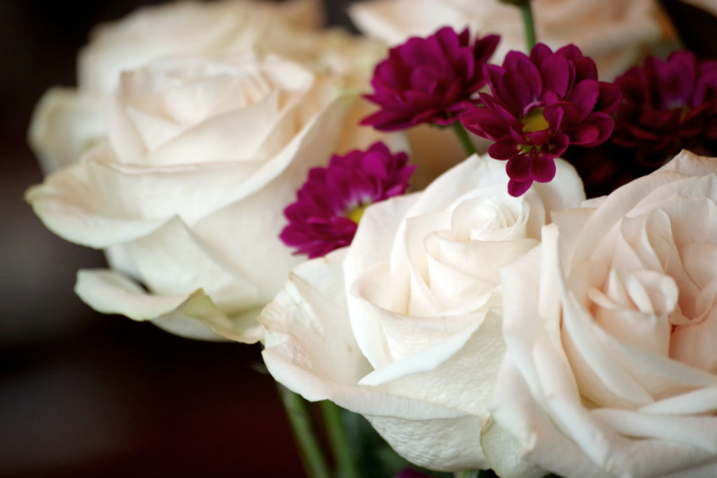 White roses signify new beginnings and hope. Mums signify optimism and joy. What better combination could there be?