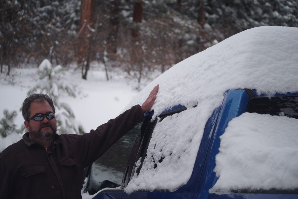 Ryc, measuring the snowcap atop my truck.